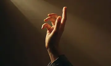 A raised hand with the index finger pointing upward